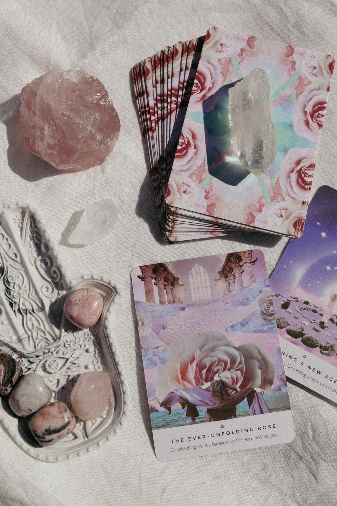 Tarot and crystals on a soft white background for spiritual guidance and healing.